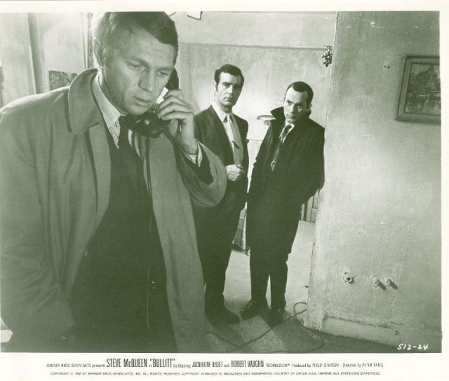 Frank Bullitt (Steve McQueen) on telephone, as 
Delgetti (Don Gordon) and Rennick (Felice Orlandi) look on from the background.